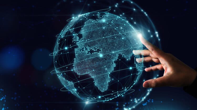 Concept image of a hand touching a digital globe.