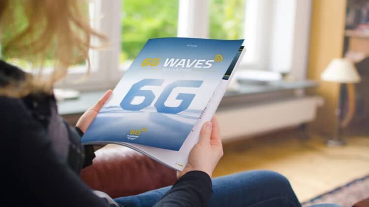 Person reading the 6G Waves magazine, showcasing the ninth issue with highlights on the latest 6G research at the University of Oulu.