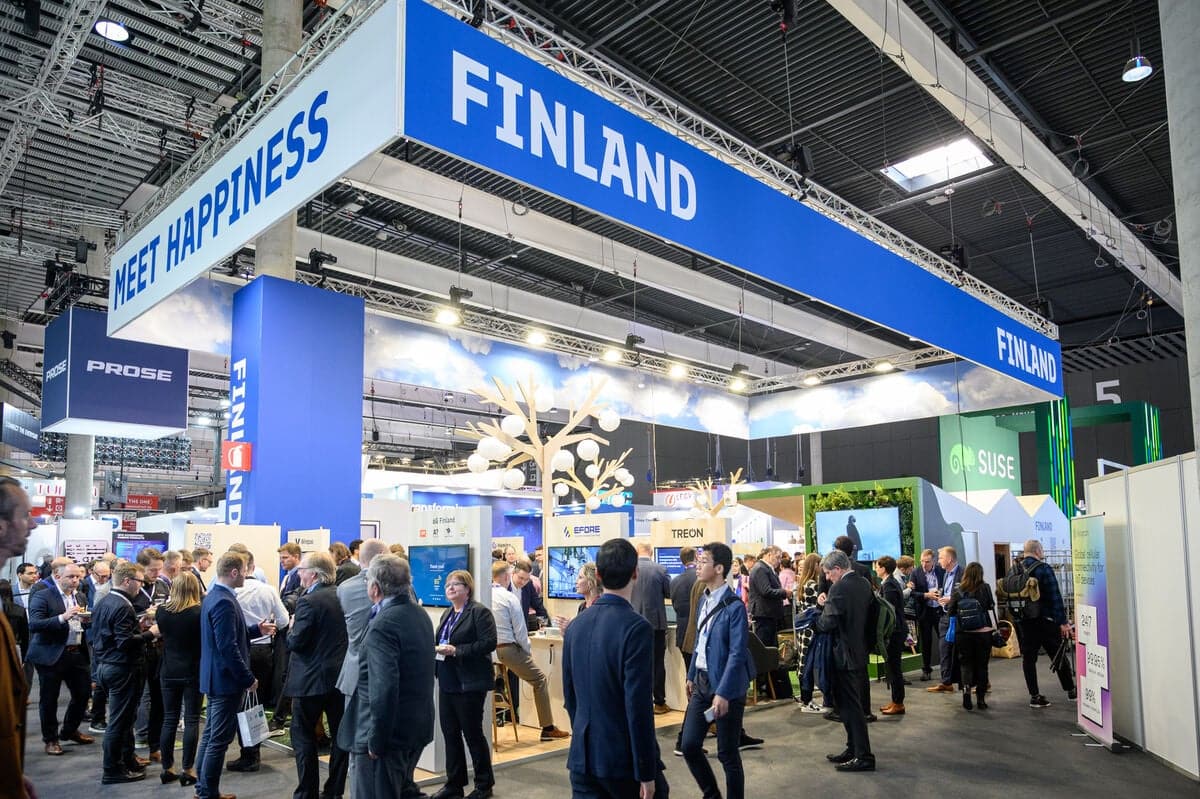 Finland Pavilion at MWC Barcelona with industry professionals networking and exploring technology innovations.