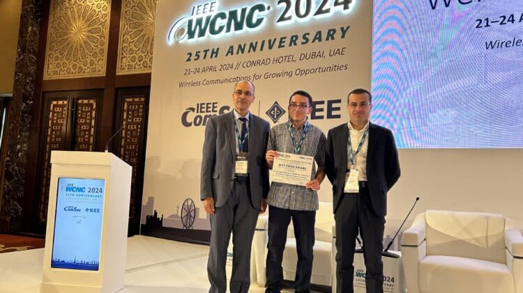 Mehdi Letafati, flanked by colleagues Raed Shubair (General Chair) and Marco Di Renzo (TPC Co-Chair), proudly receives the Best Paper Award at the IEEE WCNC 2024 25th Anniversary Conference in April 2024.
