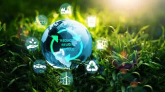 A glass globe with sustainability icons and "Reduce, Reuse, Recycle" text, symbolising environmental responsibility and green technology.